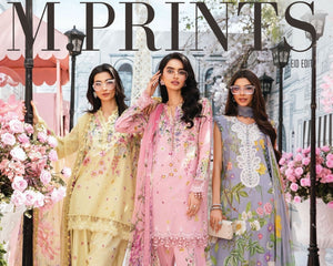 Three women in floral outfits standing in a decorative setting with 'M Prints' branding.